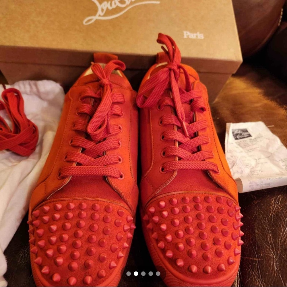 Cjristian Loubution sneakers . Sunburst red color with spikes. Gently worn.